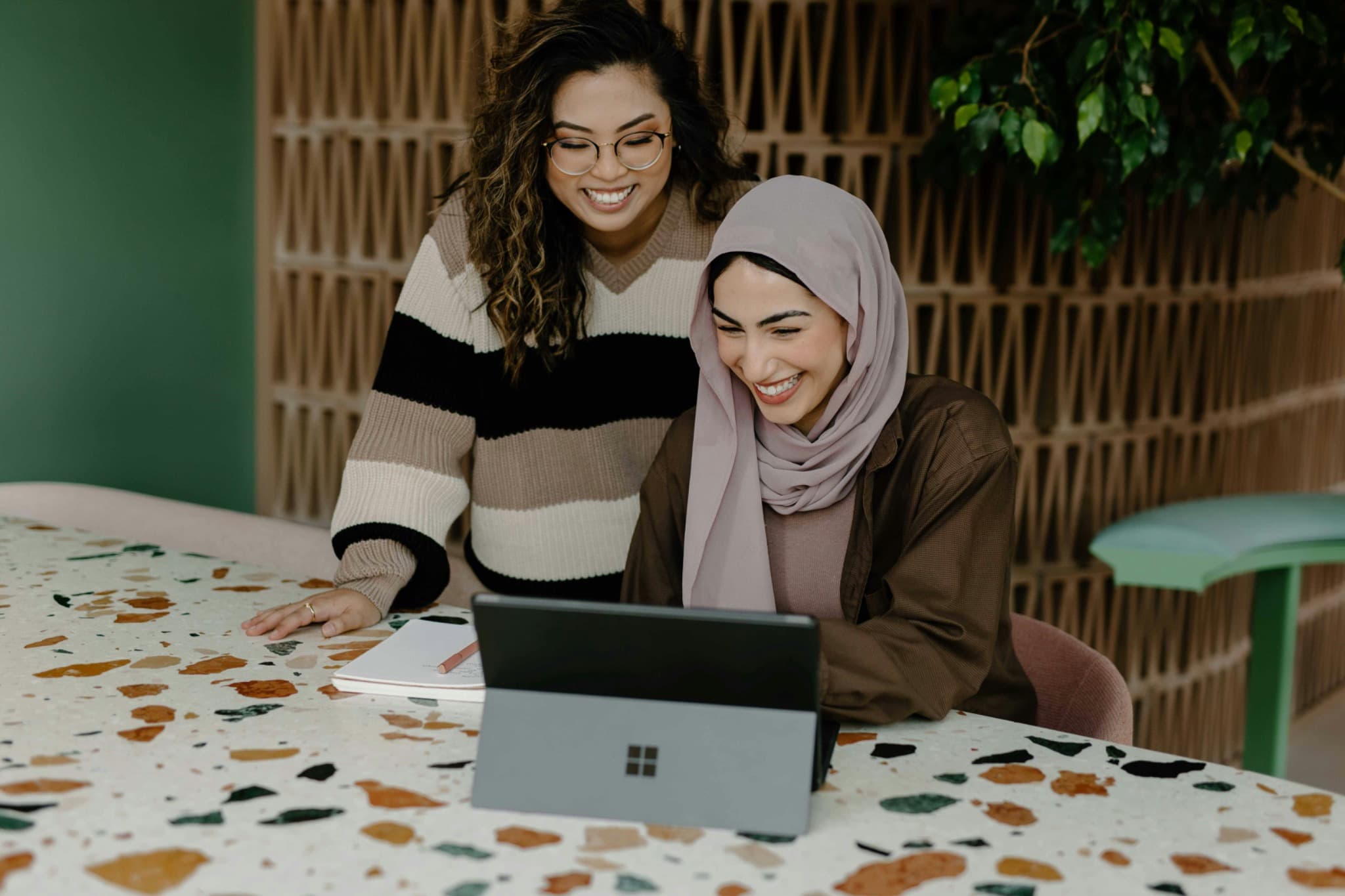 Two women collaborating on a tablet