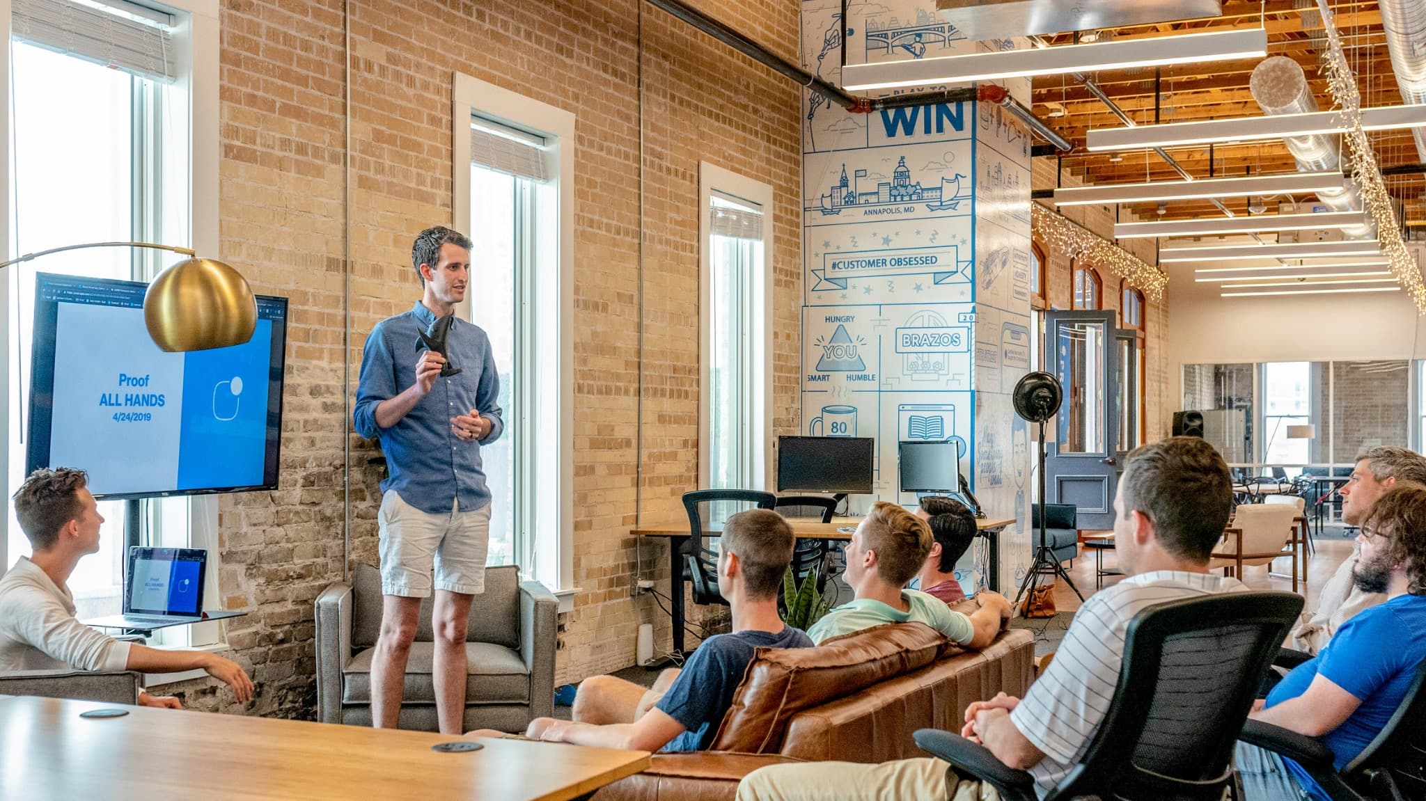 Speaker presenting to a group in an open office